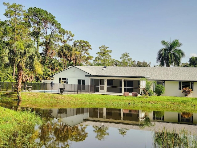 rear view of house featuring a water view