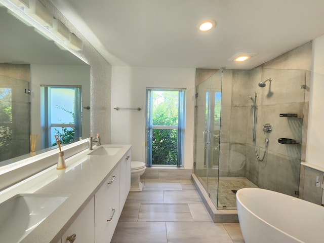 full bathroom featuring vanity, separate shower and tub, tile patterned floors, and toilet