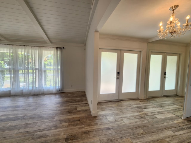 doorway to outside featuring a chandelier, lofted ceiling with beams, wood-type flooring, and french doors