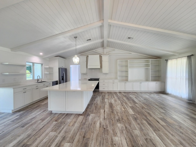 kitchen featuring sink, hanging light fixtures, stainless steel fridge with ice dispenser, light hardwood / wood-style flooring, and custom exhaust hood