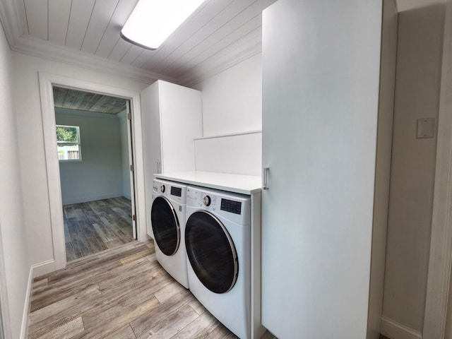 laundry room with wooden ceiling, separate washer and dryer, ornamental molding, and light hardwood / wood-style flooring