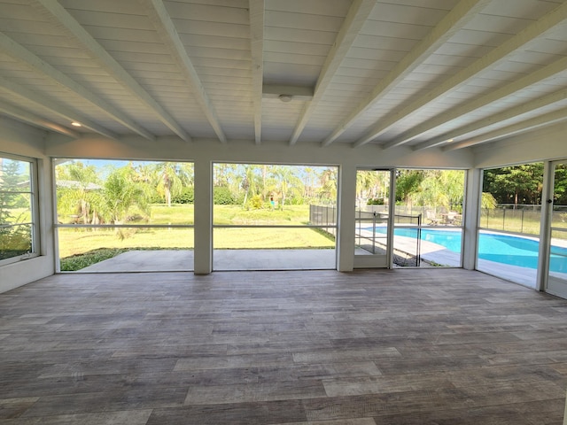 unfurnished sunroom with beamed ceiling