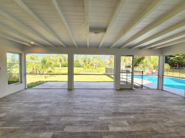 unfurnished sunroom with beamed ceiling