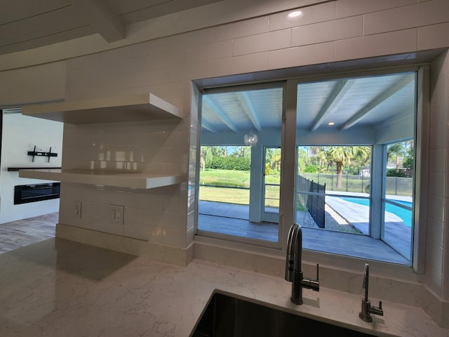 entryway featuring beam ceiling and sink