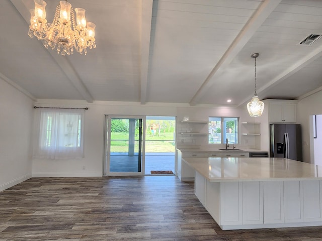 kitchen featuring stainless steel refrigerator with ice dispenser, dark hardwood / wood-style floors, white cabinetry, and a wealth of natural light