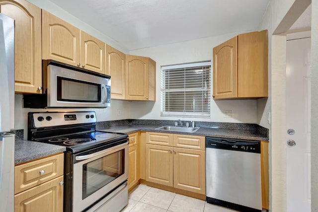 kitchen featuring light tile patterned flooring, sink, stainless steel appliances, and light brown cabinets