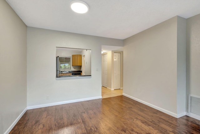 unfurnished room featuring light hardwood / wood-style flooring