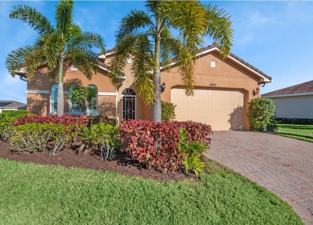 view of front facade with a garage and a front lawn