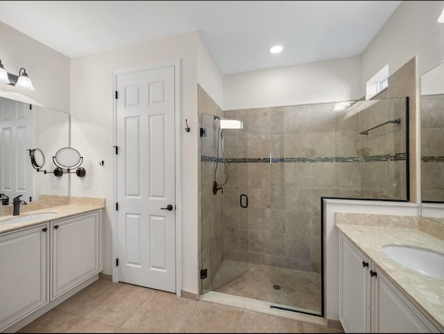 bathroom with walk in shower, tile patterned floors, and vanity