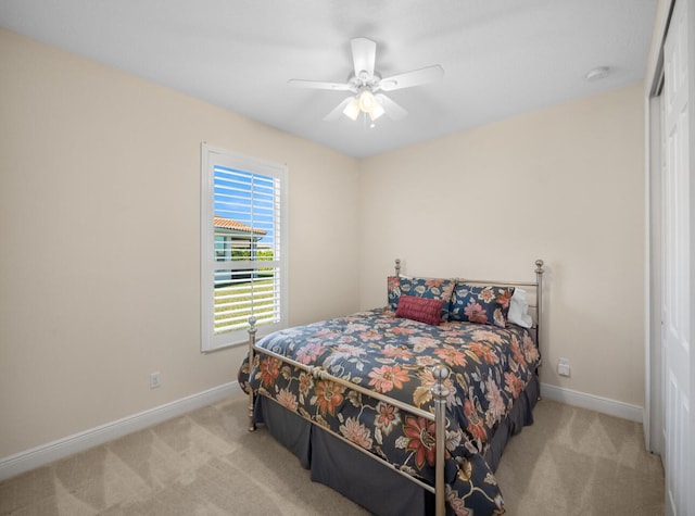 carpeted bedroom featuring ceiling fan