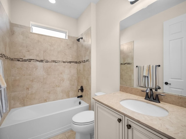 full bathroom with tile patterned floors, vanity, toilet, and tiled shower / bath combo