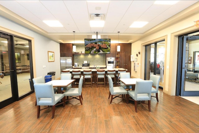 dining space featuring dark wood-type flooring