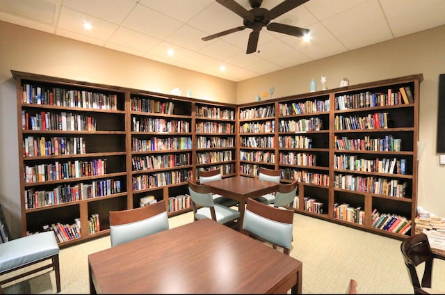 carpeted office space featuring ceiling fan