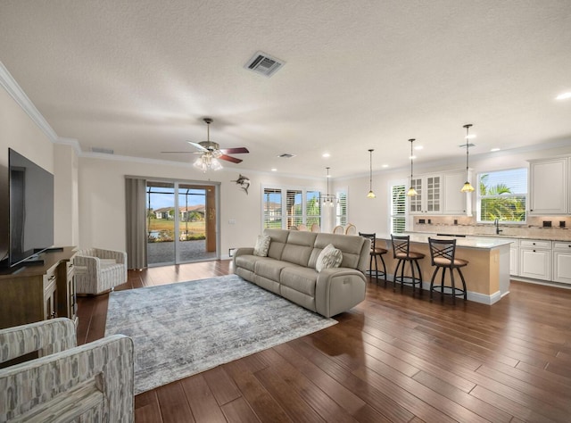 10313 SW Fernwood Ave, Port Saint Lucie, FL 34987 - living area with a ceiling fan, ornamental molding, dark wood-type flooring, and recessed lighting