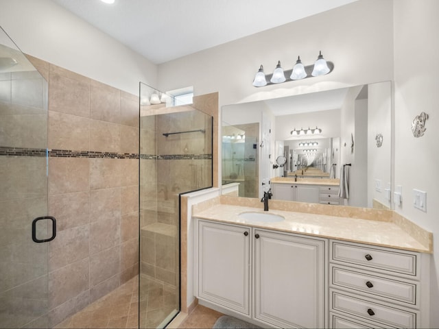 bathroom with vanity and a shower with shower door