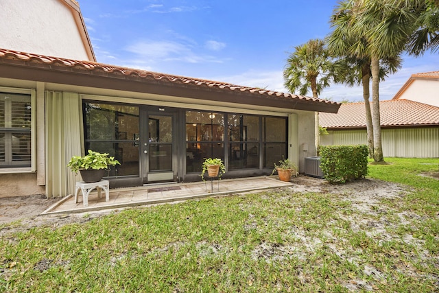 rear view of property with a lawn