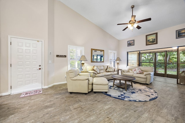 living room with ceiling fan, high vaulted ceiling, and wood-type flooring