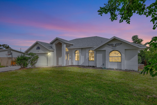 view of front of house with a lawn and a garage