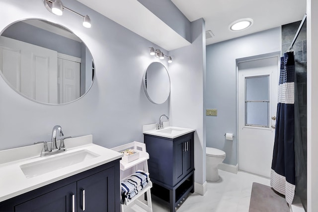 bathroom with tile patterned flooring, vanity, curtained shower, and toilet