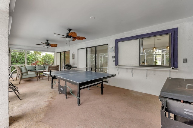 playroom with carpet flooring, ceiling fan, and a healthy amount of sunlight