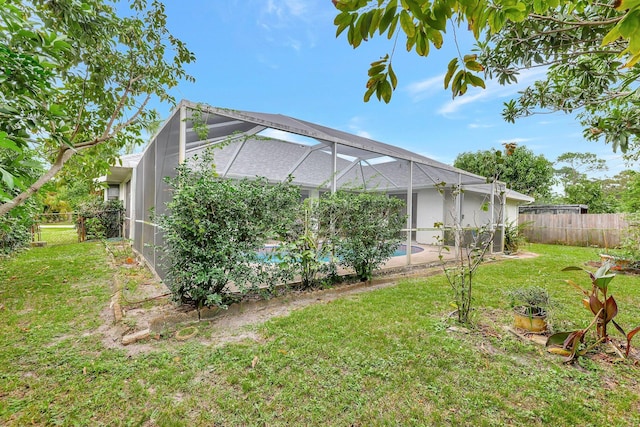 view of yard with glass enclosure