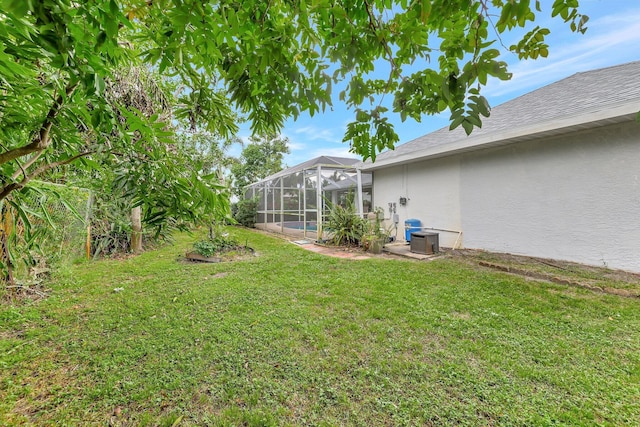 view of yard with cooling unit and a lanai