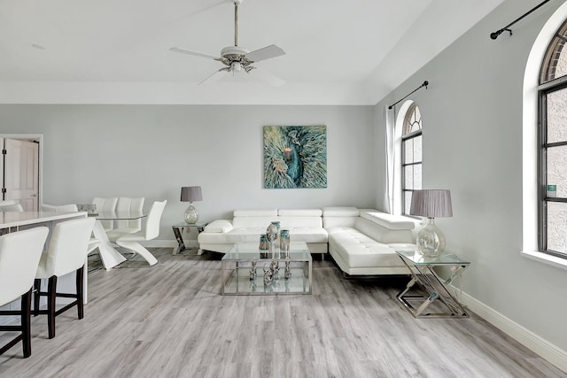 living room featuring ceiling fan, light hardwood / wood-style flooring, and a healthy amount of sunlight