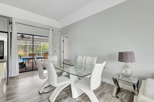 dining space with ceiling fan and light wood-type flooring