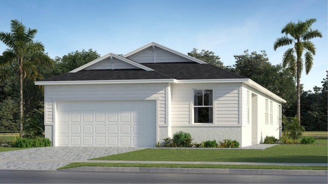 view of front of home with a garage and a front lawn