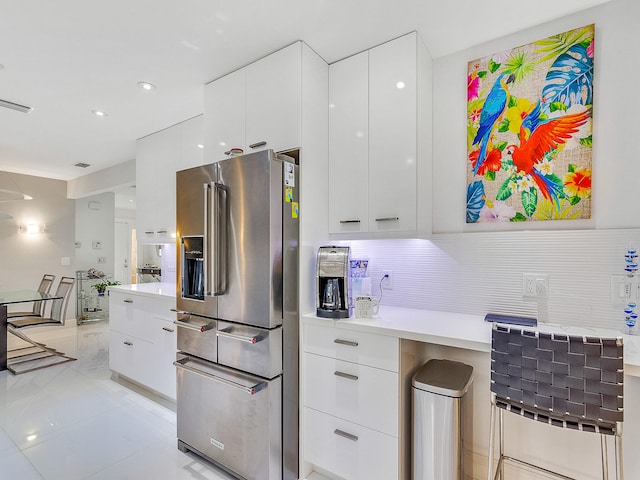 kitchen with decorative backsplash, white cabinetry, and high end fridge