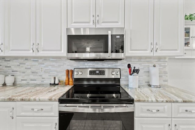 kitchen with white cabinets and appliances with stainless steel finishes