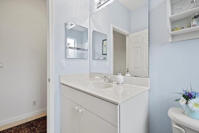 bathroom featuring tile patterned floors, vanity, and toilet