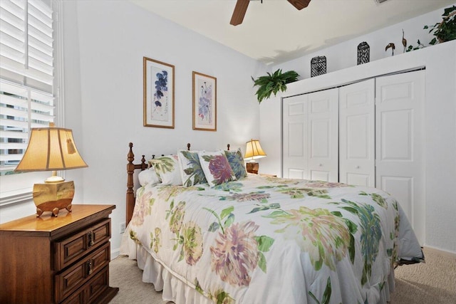 carpeted bedroom featuring a closet and ceiling fan