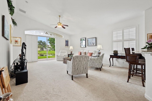 carpeted living room featuring vaulted ceiling and ceiling fan