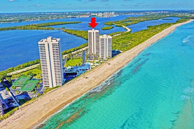 drone / aerial view featuring a water view and a beach view