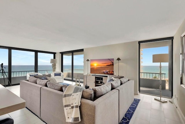 living room featuring a water view and expansive windows