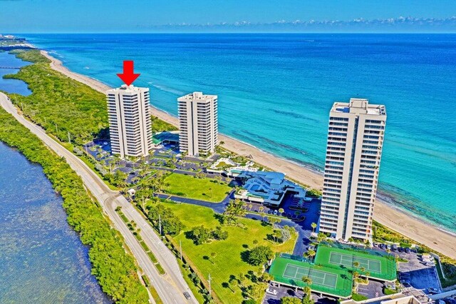 drone / aerial view featuring a water view and a view of the beach