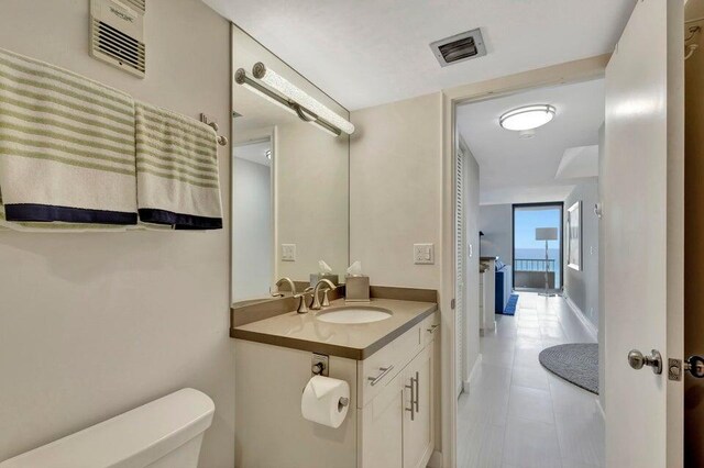 bathroom featuring tile patterned floors, vanity, and toilet