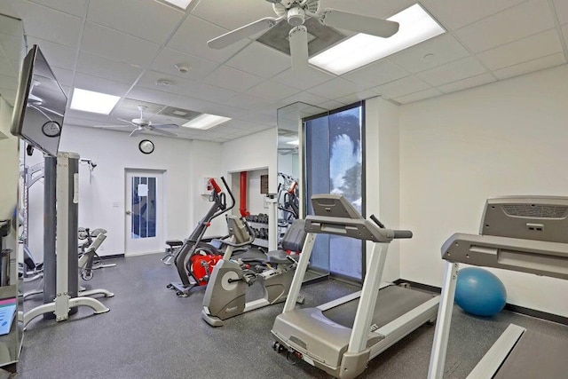 workout area featuring a drop ceiling and ceiling fan