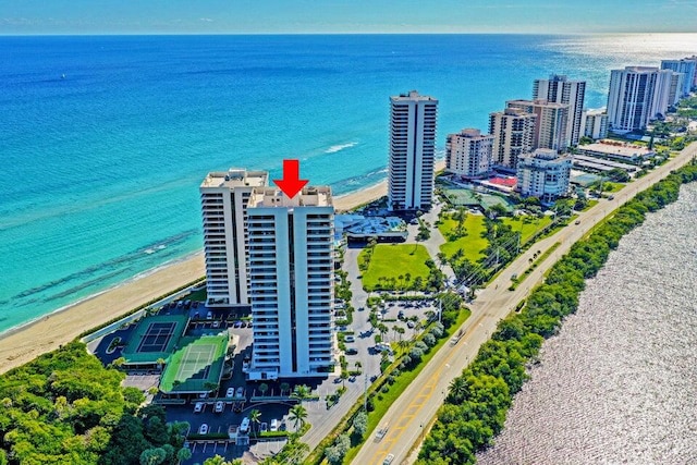 birds eye view of property with a beach view and a water view