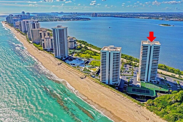 drone / aerial view with a water view and a beach view