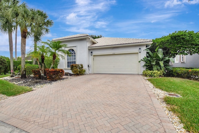 mediterranean / spanish-style home with a garage