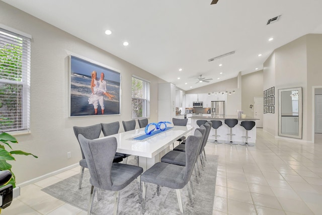 tiled dining room featuring vaulted ceiling and ceiling fan