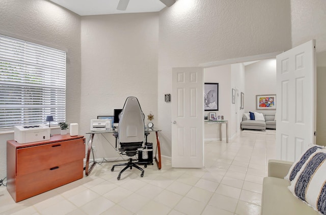 tiled office featuring ceiling fan