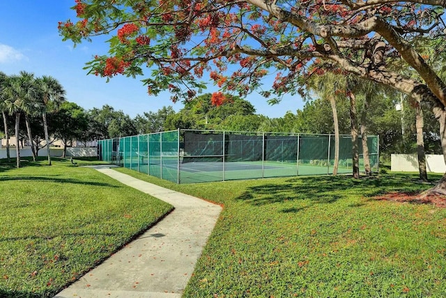 view of sport court with a yard