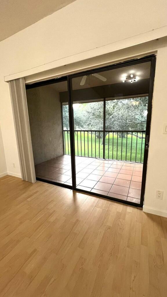 doorway to outside featuring light hardwood / wood-style floors, plenty of natural light, and ceiling fan