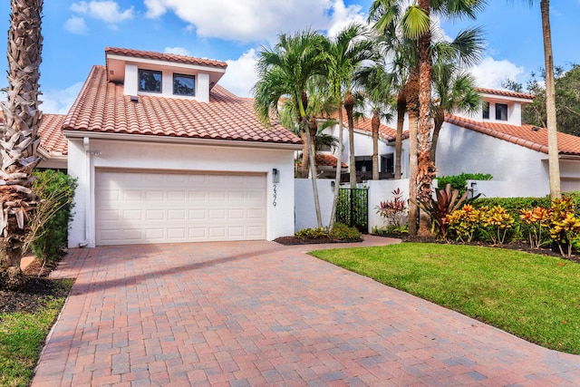 mediterranean / spanish home featuring a front lawn