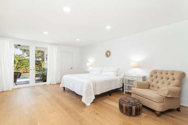 bedroom featuring access to exterior and light wood-type flooring