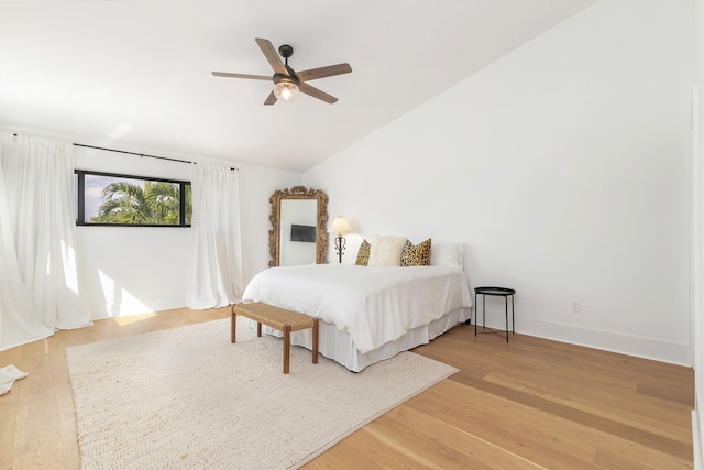 bedroom featuring hardwood / wood-style floors, ceiling fan, and vaulted ceiling