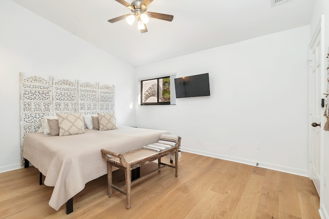 bedroom with ceiling fan, light wood-type flooring, and lofted ceiling